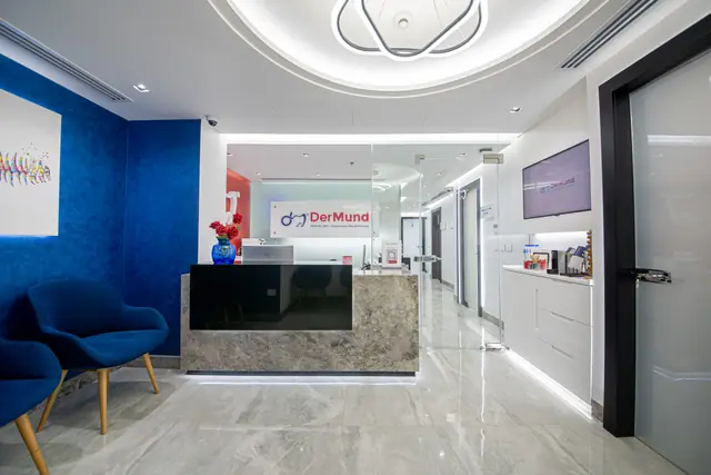 DerMund reception with navy seating and the clinic logo